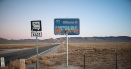 Welcome to Nevada road sign on Route 266 East, with a desert landscape in the background