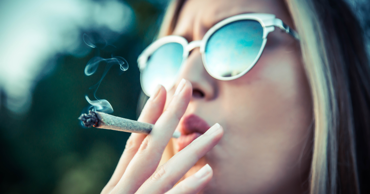 woman smoking marijuana while in the influence of alcohol