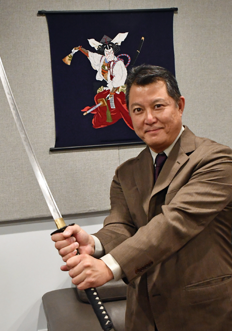 Garrett T Ogata holding a Samurai Sword